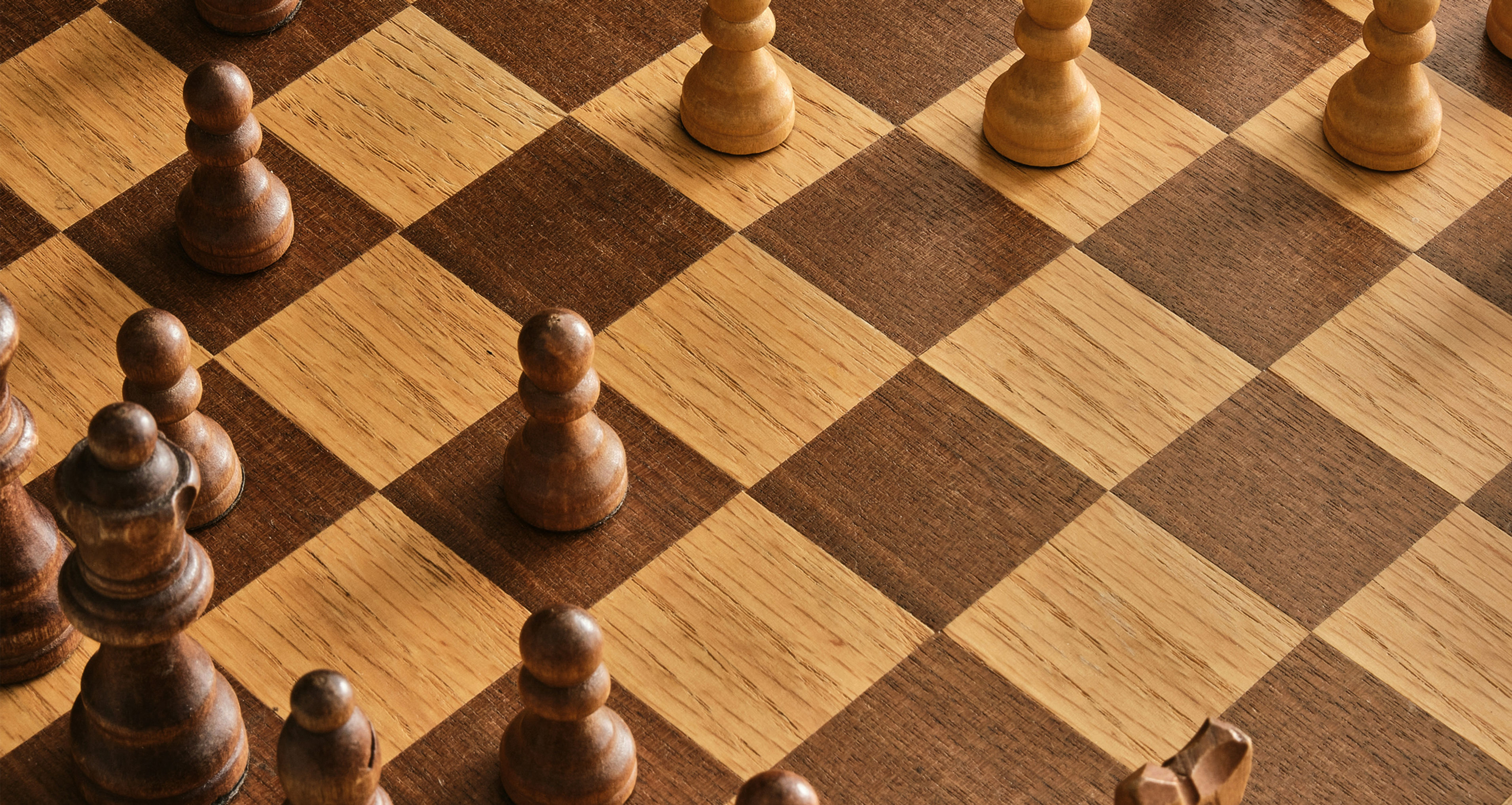 Wooden chess board with pieces arranged for strategic play